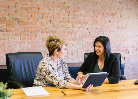 A photo of a consultant offering consultation service to her client; a small business ideas