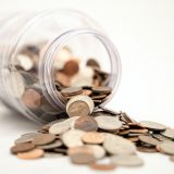 Coins and a fallen jar illustrate how you can make an extra income