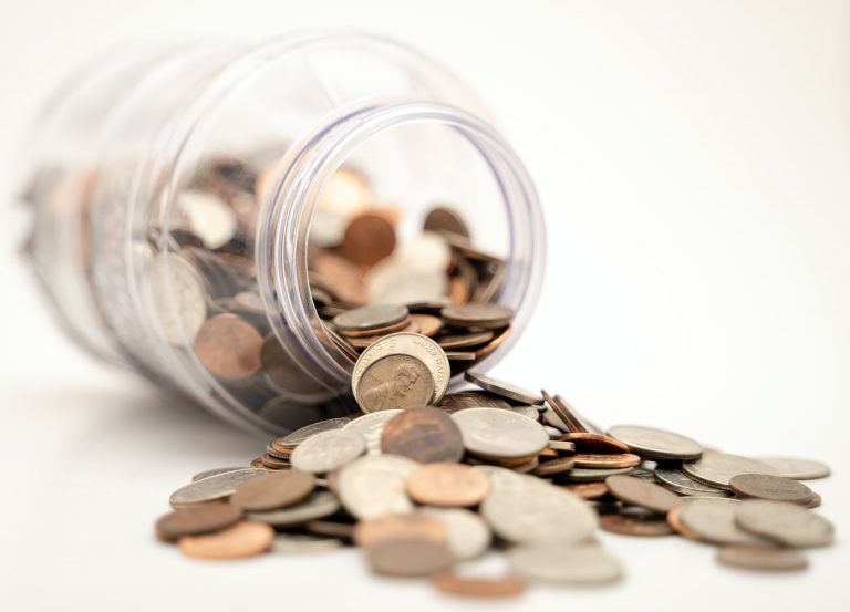 Coins and a fallen jar illustrate how you can make an extra income