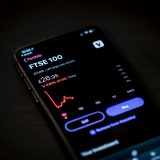 A phone showing stock and cryptocurrency trading