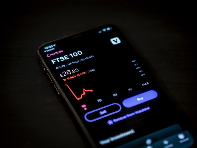 A phone showing stock and cryptocurrency trading